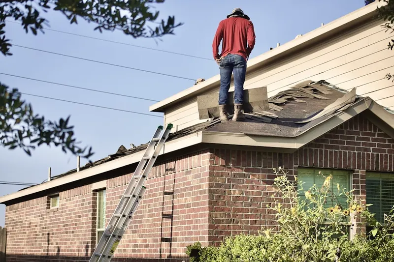 Professional roofer working on a residential roof in Lakota